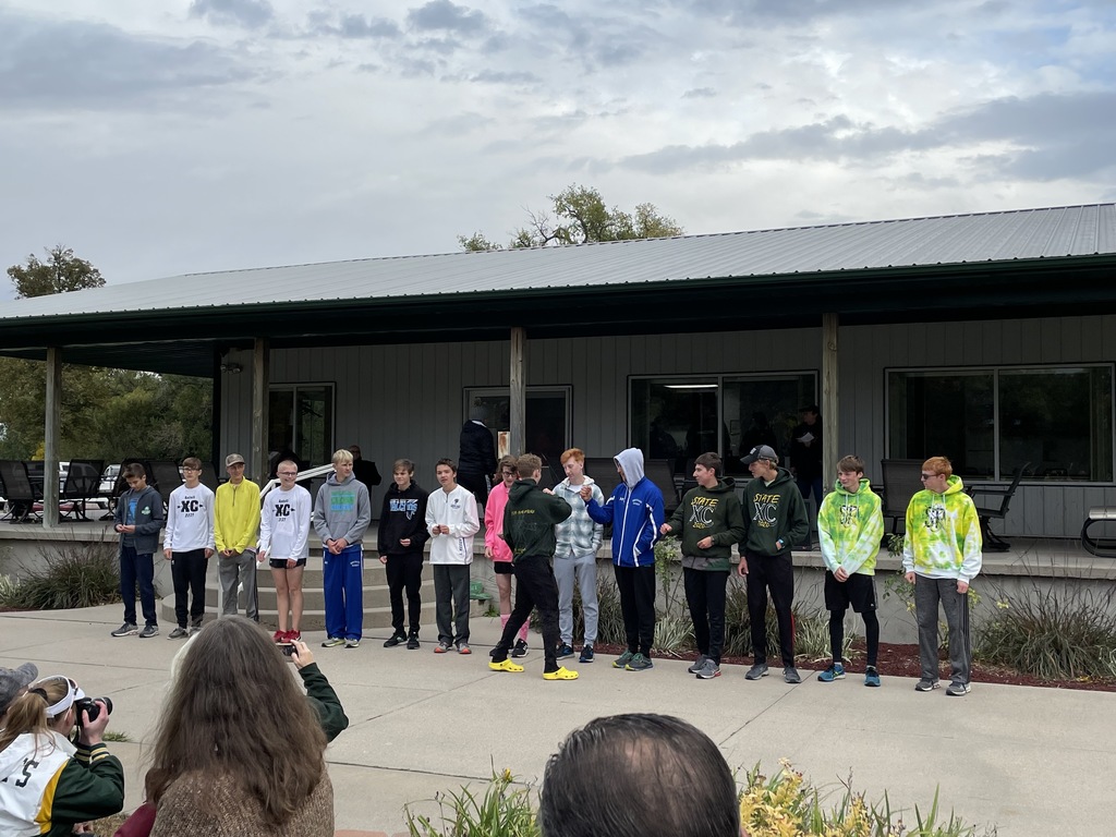 Isaiah and Micah receiving medals at district cross country 2021